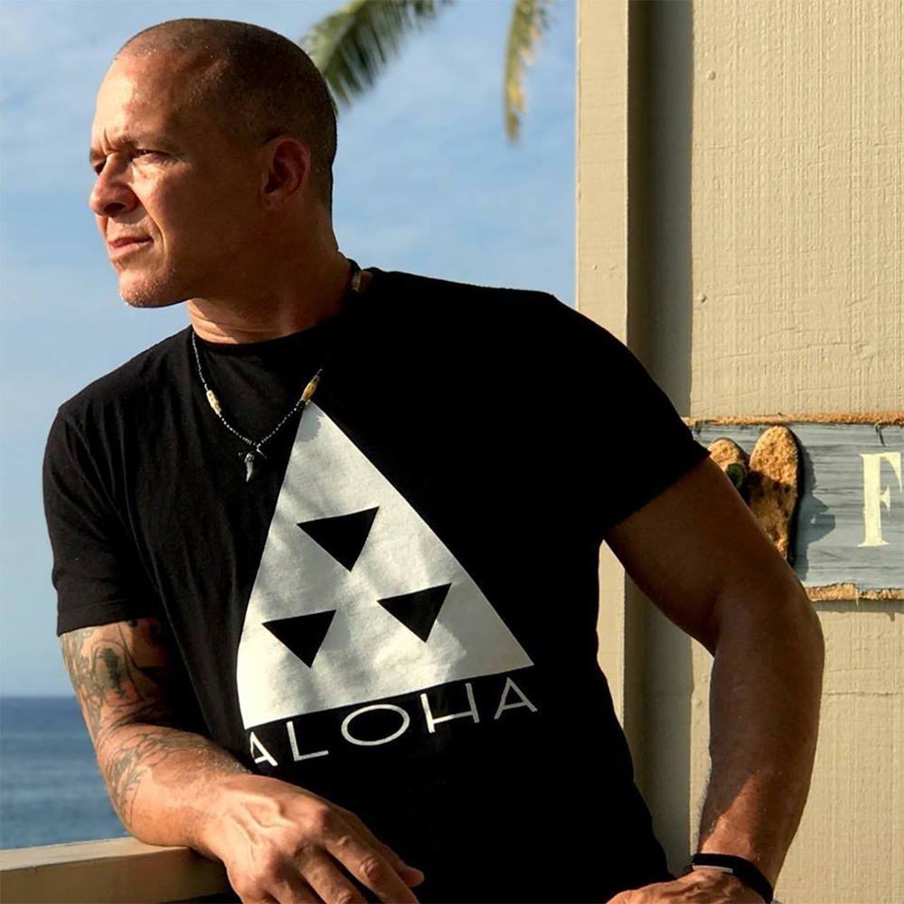 Original Aloha triangle tee worn beside the ocean